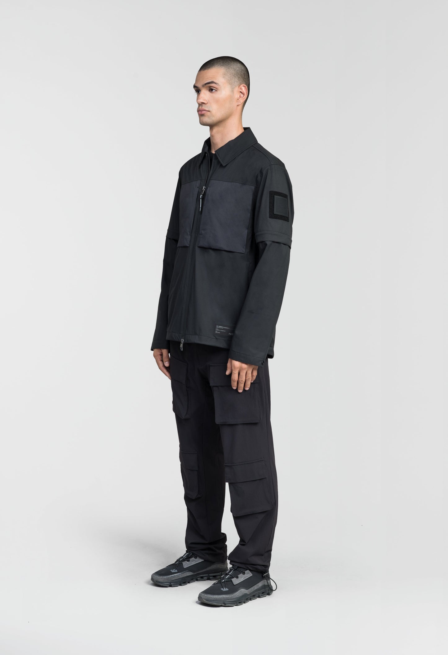 Thurlow Men's Performance Zip Off Sleeve Rain Shirt in hip length, convertible collar, patch chest zipper pockets, hidden in-seam pockets, zip off sleeves, centre front two-way zipper closure, in Black