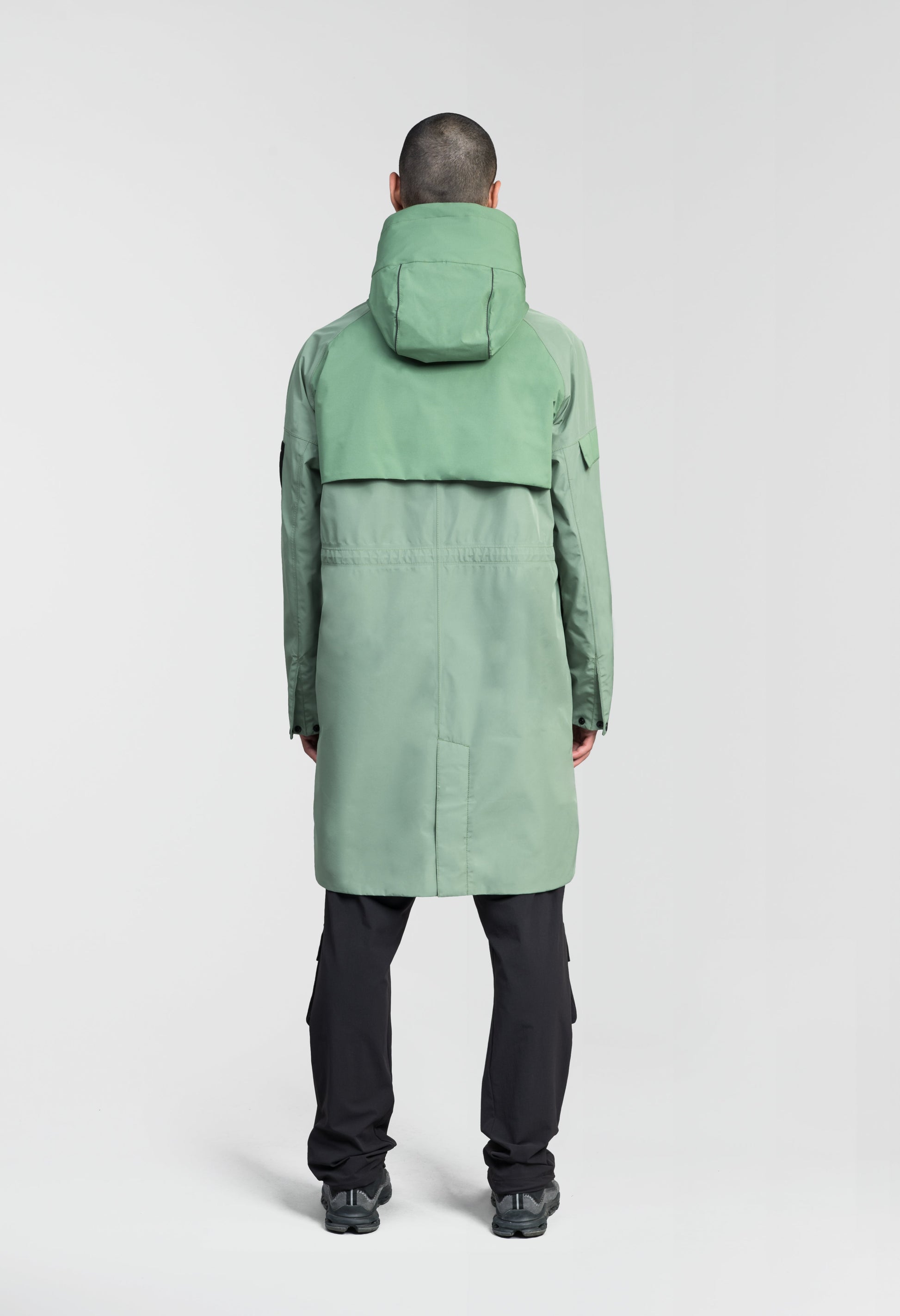 Wylder Men's Performance Rain Jacket in knee length, premium 3-ply Micro Denier and stretch ripstop fabrication, non-removable hood with reflective piping and adjustable draw cord, split utility chest pocket with magnetic flap closure, single welt pockets with magnetic closure at waist, back yoke with mesh ventilation, snap button wind flap, two-way branded zipper at centre front, telescopic sleeves with elasticized cuffs, interior draw cord at waist, in Comfrey