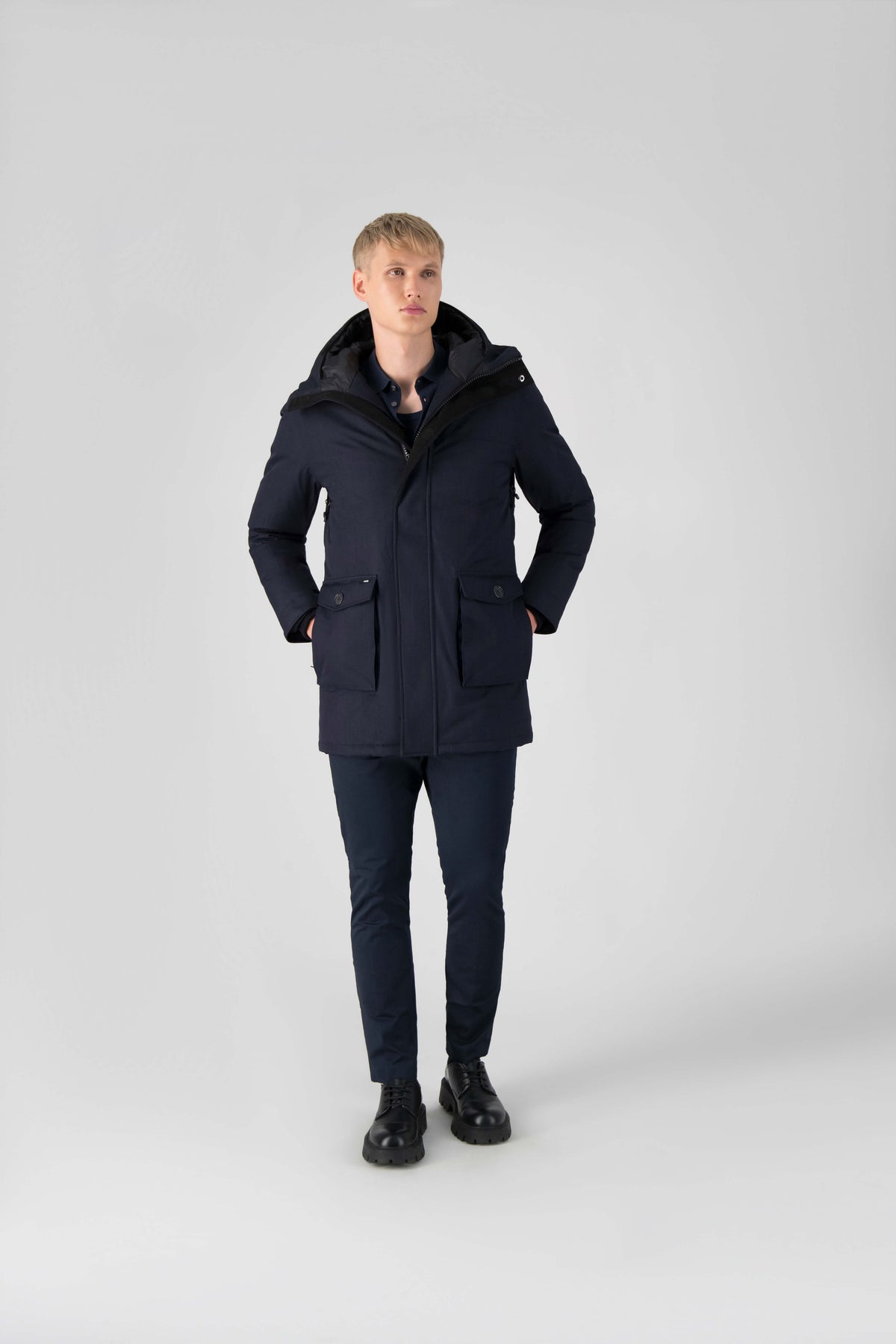 Men's slim fitting waist length parka with removable fur trim on the hood and two waist patch pockets in Navy