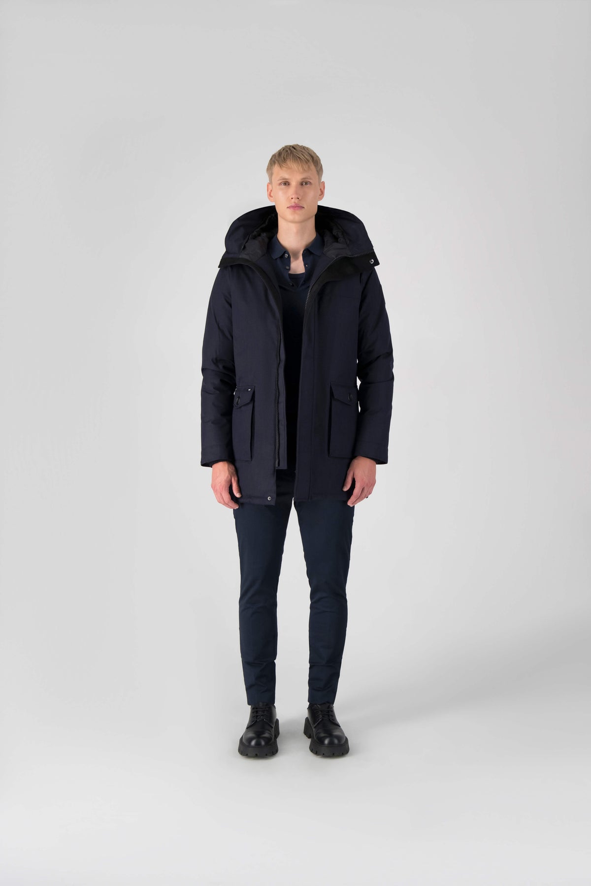 Men's slim fitting waist length parka with removable fur trim on the hood and two waist patch pockets in Navy