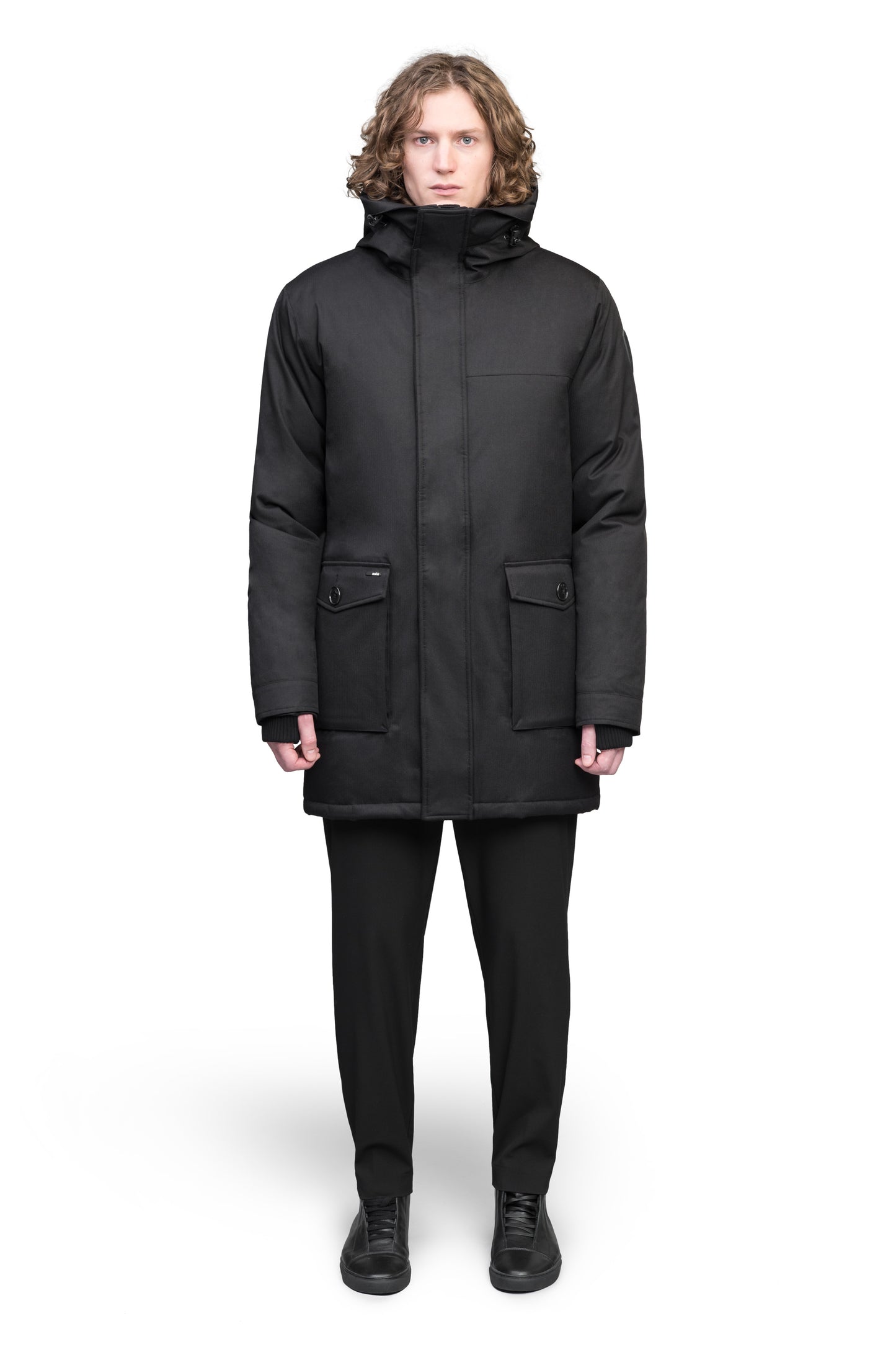 Yves Furless Men's Parka in thigh length, Canadian white duck down insulation, non-removable down-filled hood, flap pockets at waist, centre-front two-way zipper with magnetic wind flap, and elastic ribbed cuffs, in Black