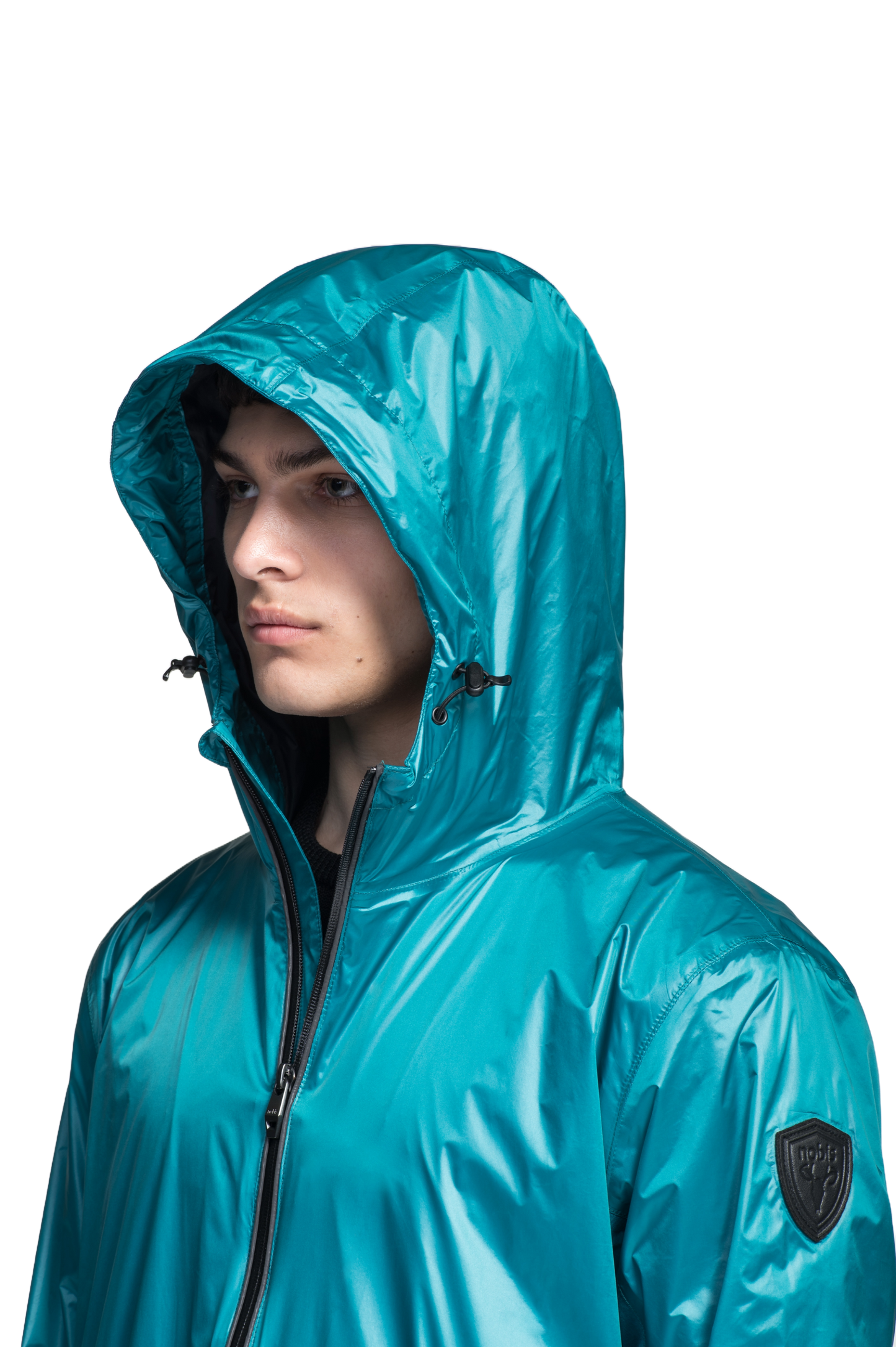 Stratus Men's Tailored Packable Rain Jacket in hip length, premium cire technical nylon taffeta and stretch ripstop fabrication, highly breathable mesh lining, hidden packable pocket, non-removable hood with adjustable draw cord, reflective piping along front and back, underarm grommets for extra breathability, back yoke with mesh ventilation, two waist zipper pockets, two interior zipper pockets, elastic cuffs with adjustable snap button, and adjustable interior draw cord at waist hem, in Deep Lake