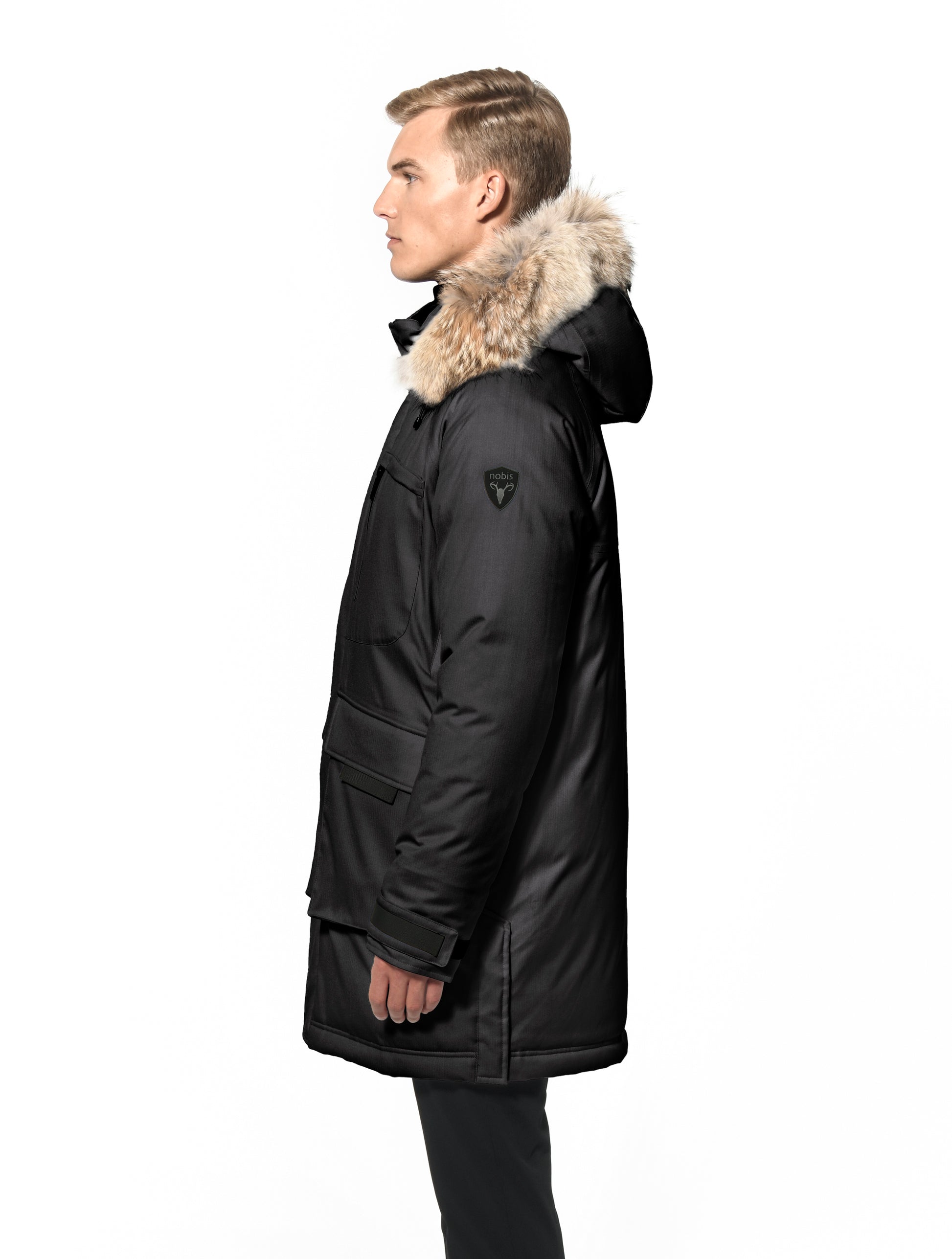 Men's thigh length down-filled parka with removable hood and removable coyote fur trim in Black
