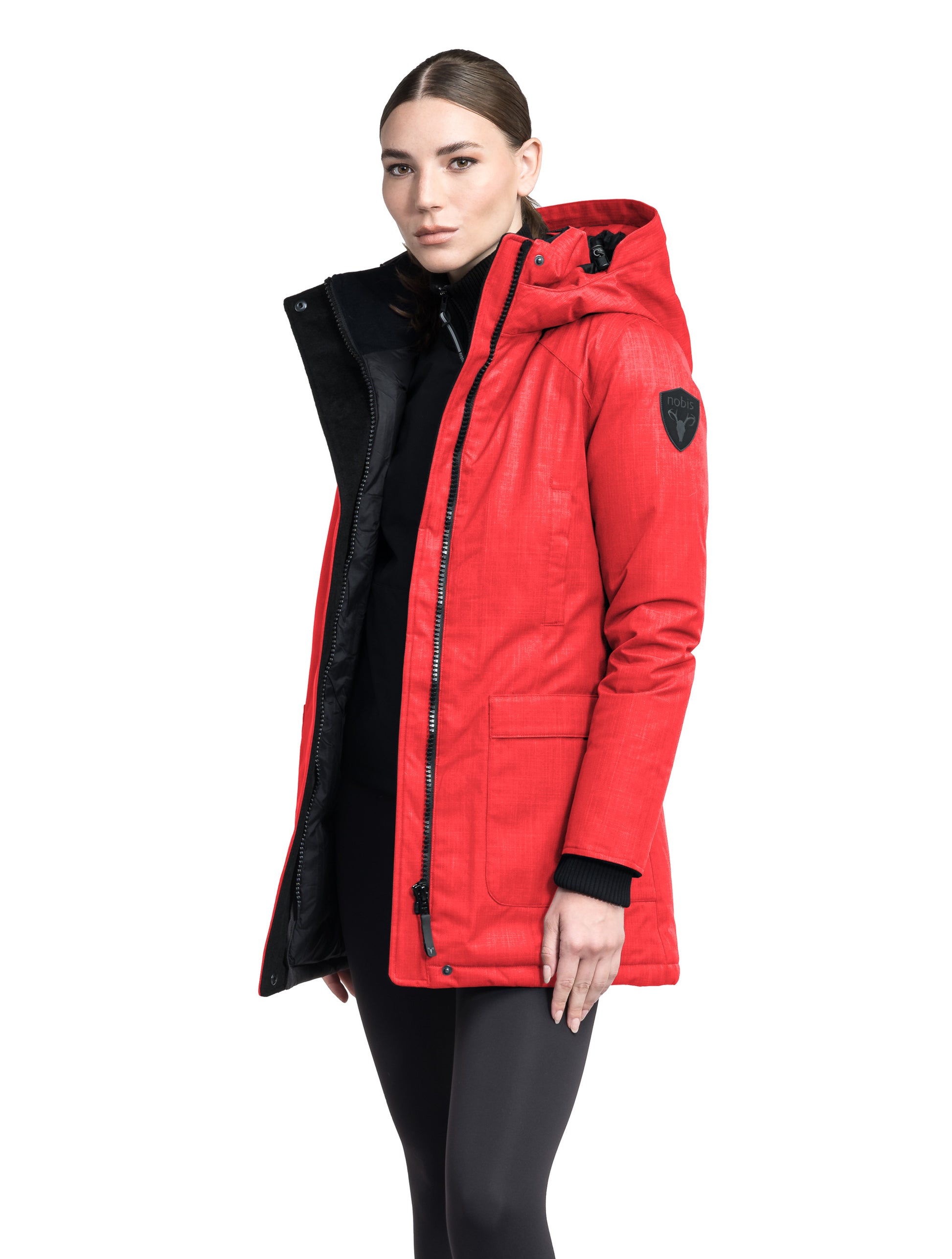 Women's down filled parka that sits just below the hip with a clean look and two hip patch pockets in BlackCarla Furless Ladies Parka in thigh length with Canadian Premium White Duck Down insulation, non-removable hood, centre-front zipper with magnetic closure wind flap, and four exterior pockets, in Vermillion