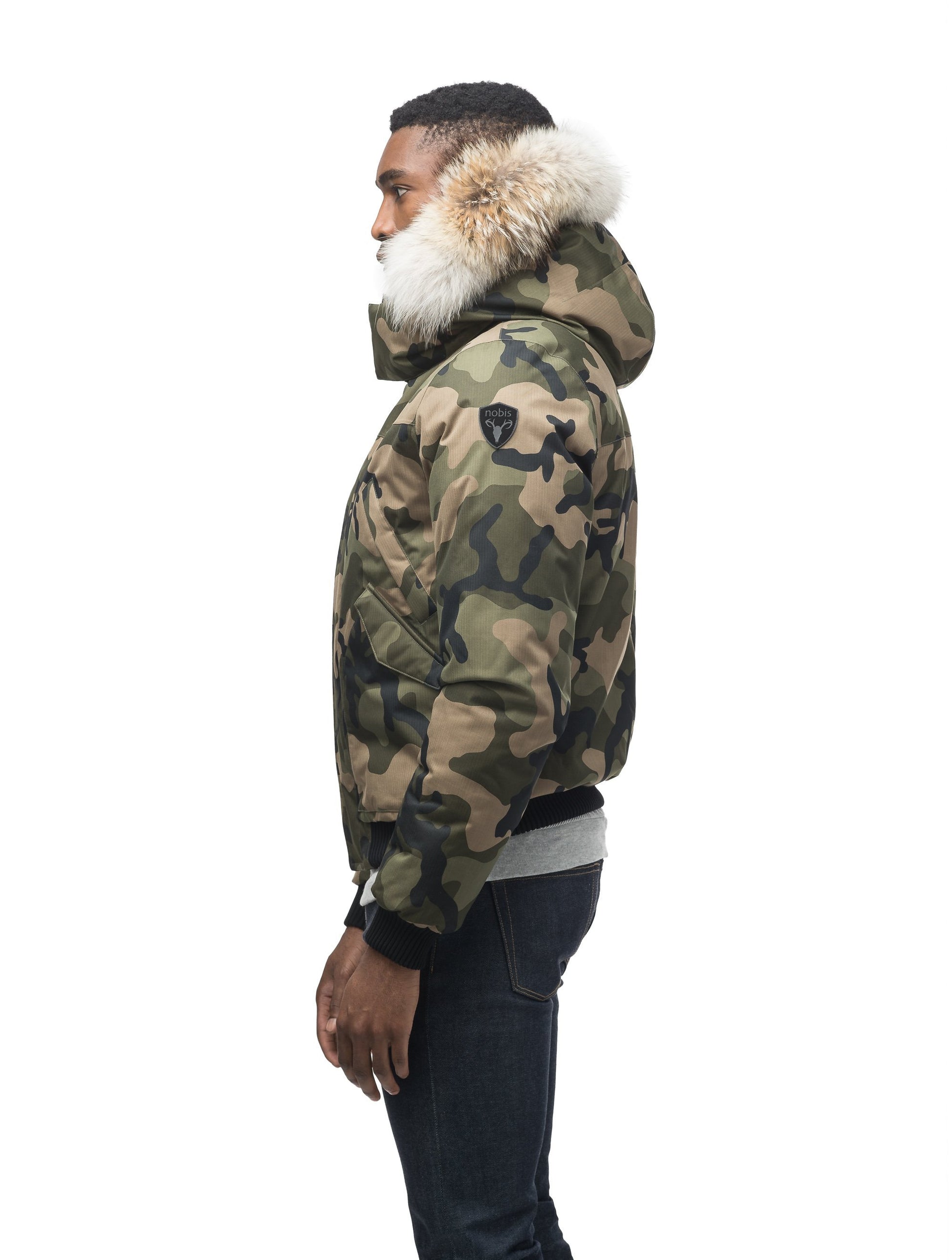 Men's classic down filled bomber jacket with a down filledÃ‚Â hood that features a removable coyote fur trim and concealed moldable framing wire in Camo