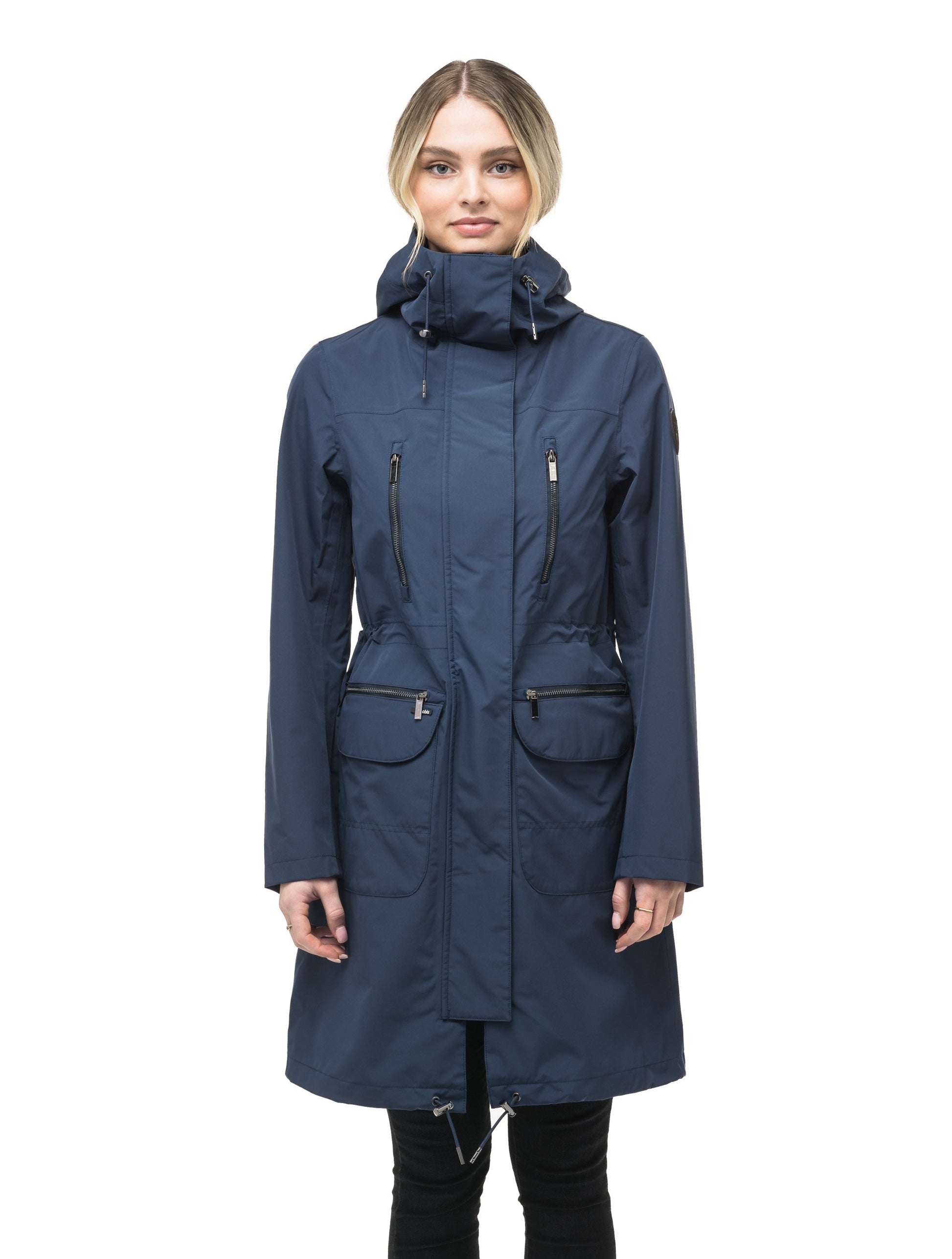 Women's knee length anorak with four front pockets and adjustable cord waist in Marine