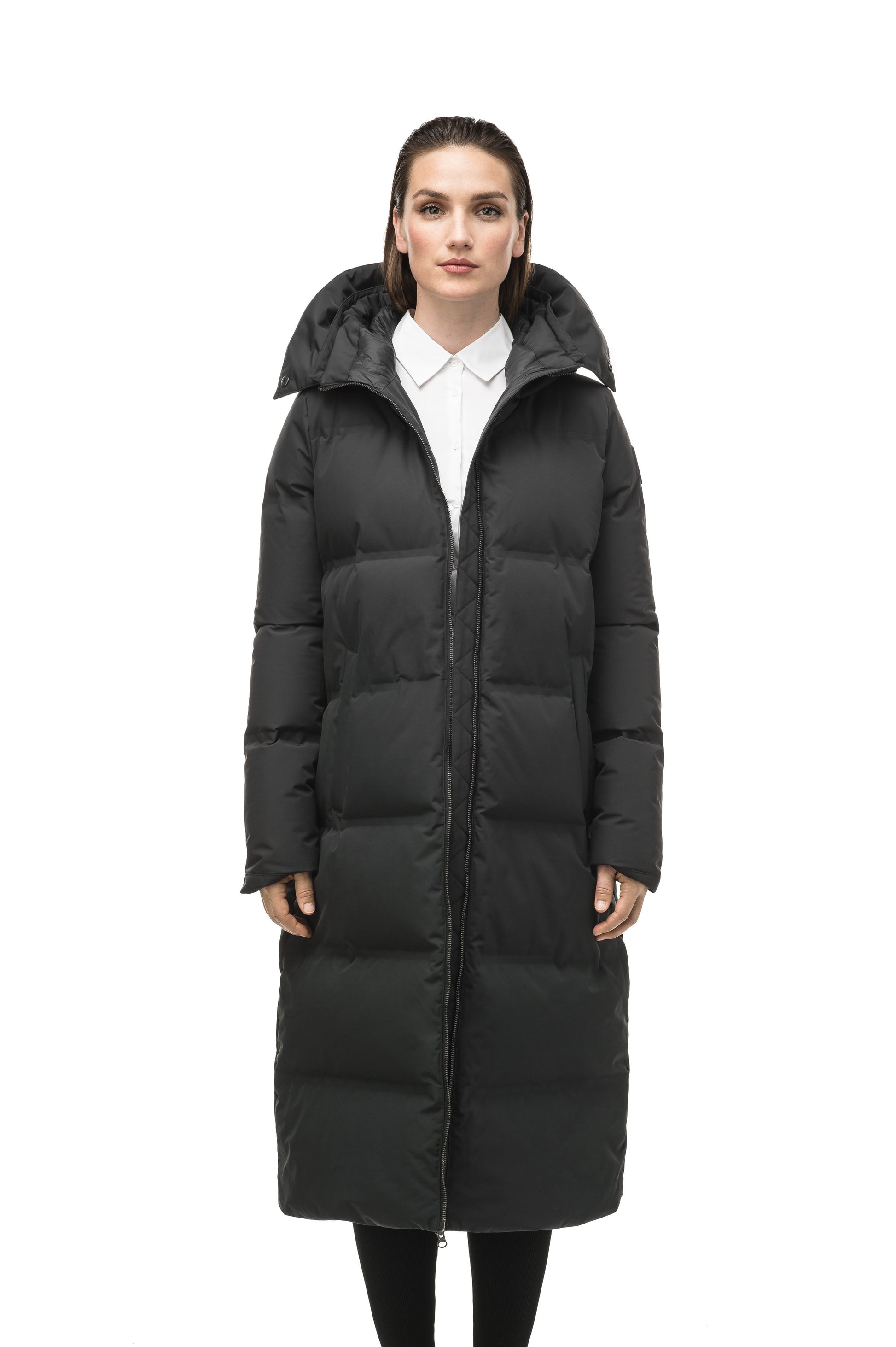 Women's ankle length puffer jacket with a minimalist modern design,ÃƒÆ’Ã†â€™ÃƒÂ¢Ã¢â€šÂ¬Ã…Â¡ÃƒÆ’Ã¢â‚¬Å¡Ãƒâ€šÃ‚Â featuring an exposed zipper, and seamless puffer channels in Black