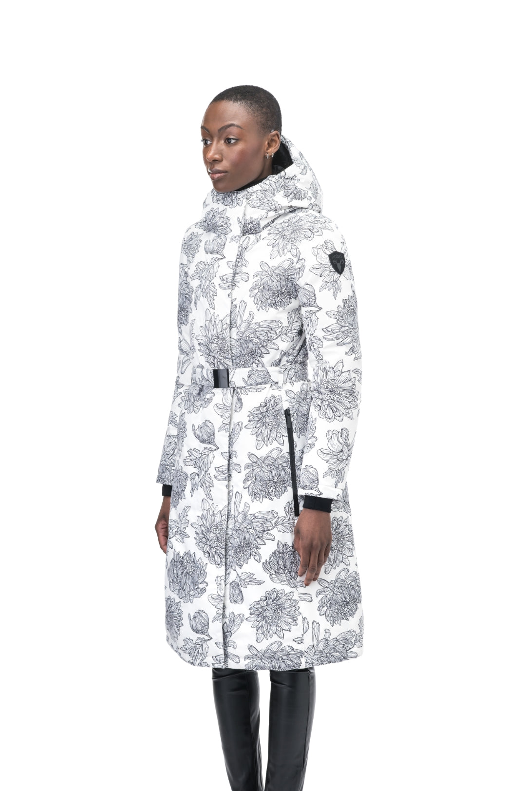 Long calf length hooded women's winter parka with an inner hip length closure, exterior hem length zipper and magnetic placket in White Floral