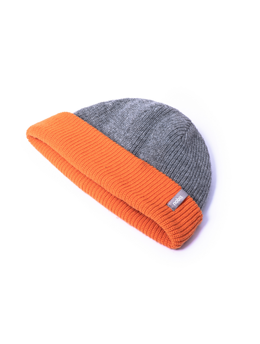 Knitted reversible beanie with grey side displayed.