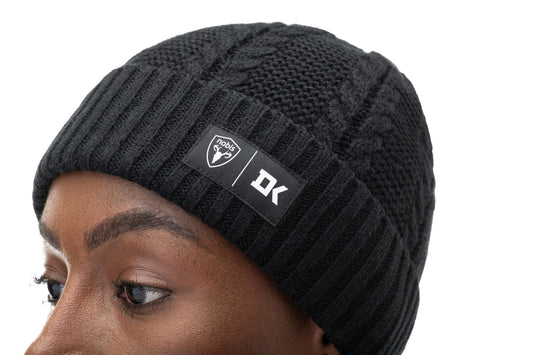 Duncan Keith x Nobis Unisex Cable Knit Beanie with cable stitched crown, two by two rib knit cuff, with co-branding label that features Keith's initials on cuff, in Black