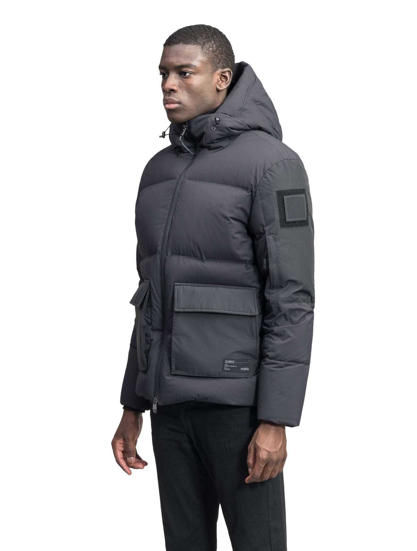 Supra Men's Performance Puffer in hip length, Technical Taffeta and 3-Ply Micro Denier fabrication, Premium Canadian White Duck Down insulation, non-removable down filled hood, centre front two-way zipper, flap pockets at waist, and zipper pocket at left bicep, in Black
