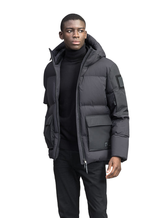 Supra Men's Performance Puffer in hip length, Technical Taffeta and 3-Ply Micro Denier fabrication, Premium Canadian White Duck Down insulation, non-removable down filled hood, centre front two-way zipper, flap pockets at waist, and zipper pocket at left bicep, in Black