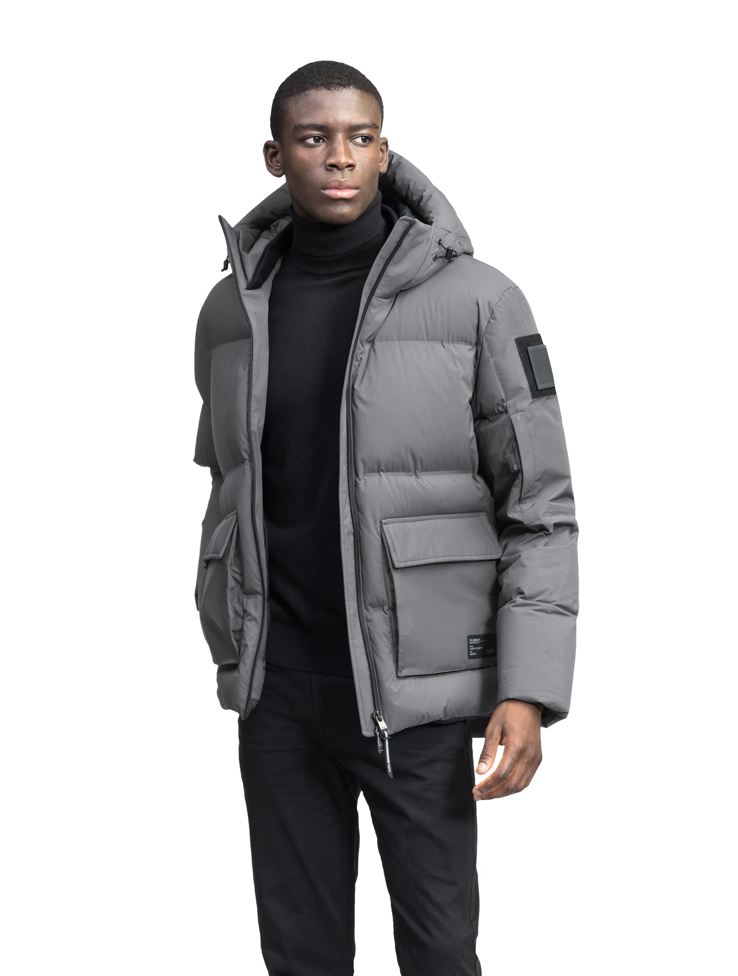 Supra Men's Performance Puffer in hip length, Technical Taffeta and 3-Ply Micro Denier fabrication, Premium Canadian White Duck Down insulation, non-removable down filled hood, centre front two-way zipper, flap pockets at waist, and zipper pocket at left bicep, in Concrete